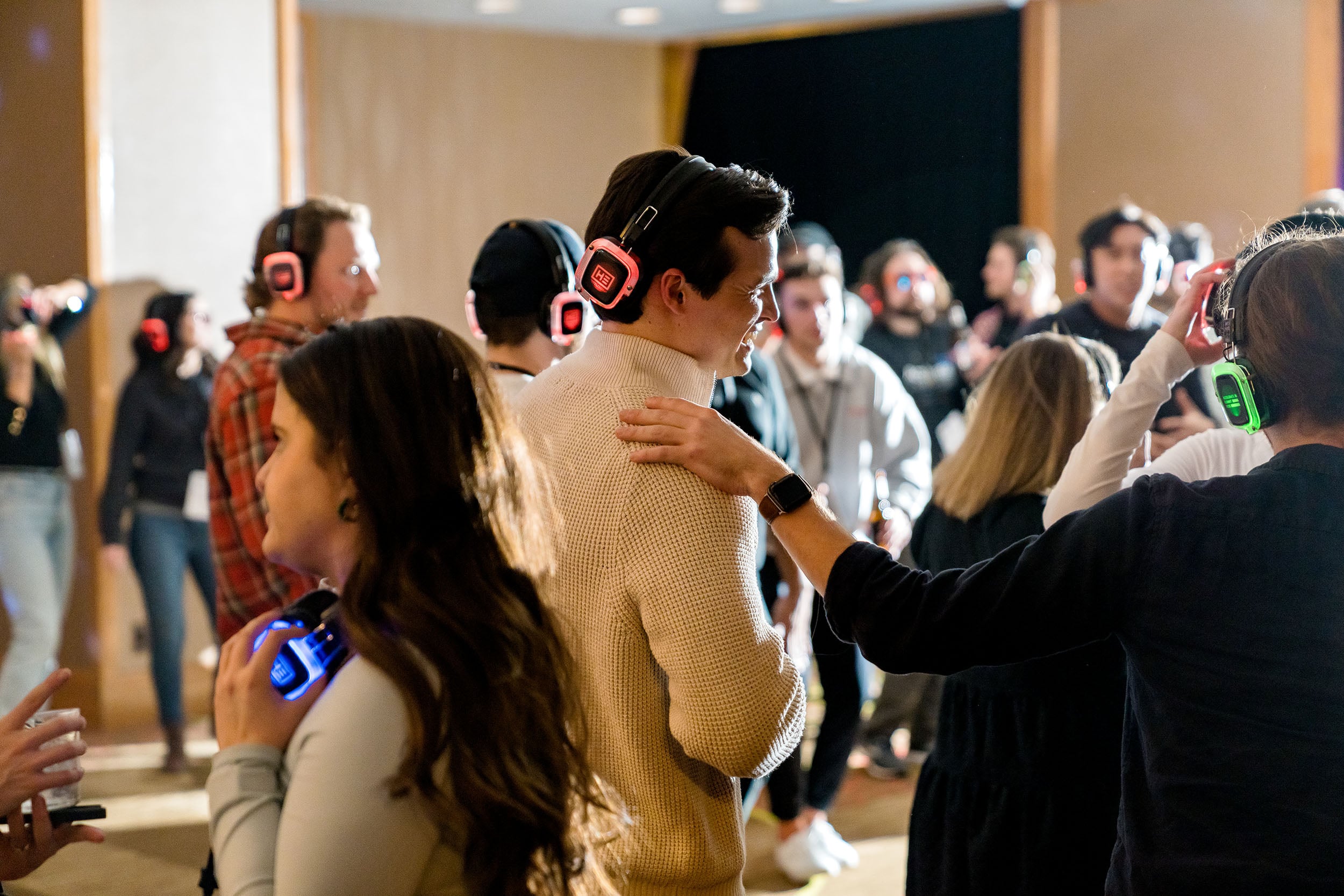 Silent disco holiday party with people enjoying themselves.