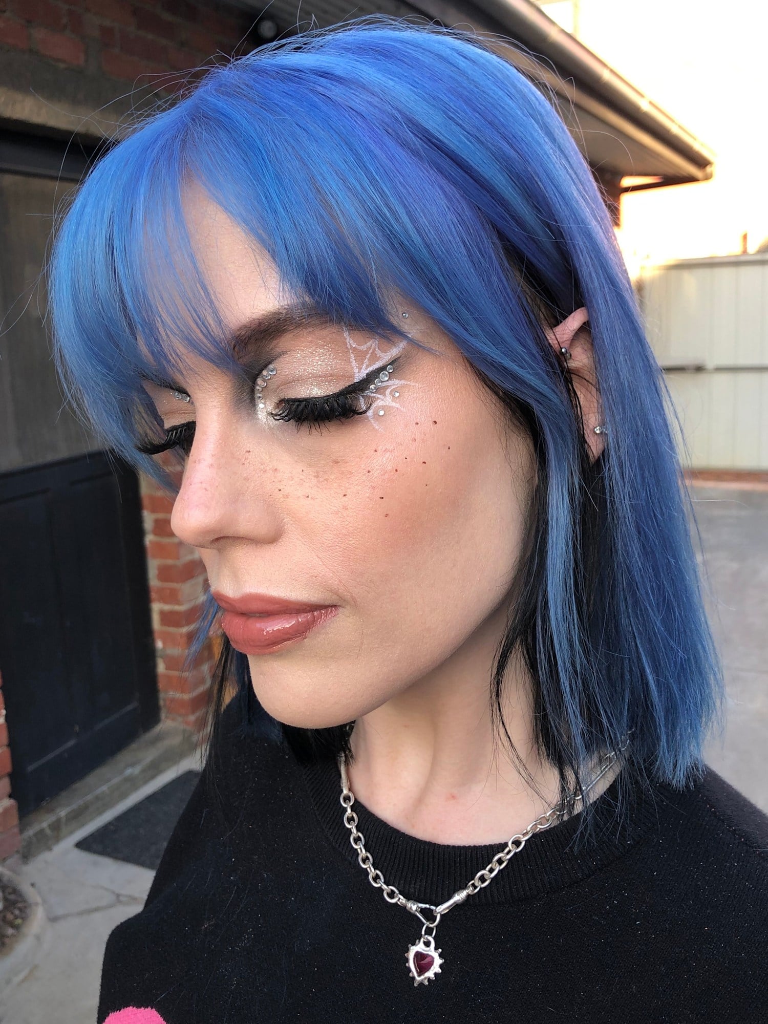Blue hair with a sharp black wing and silver detail