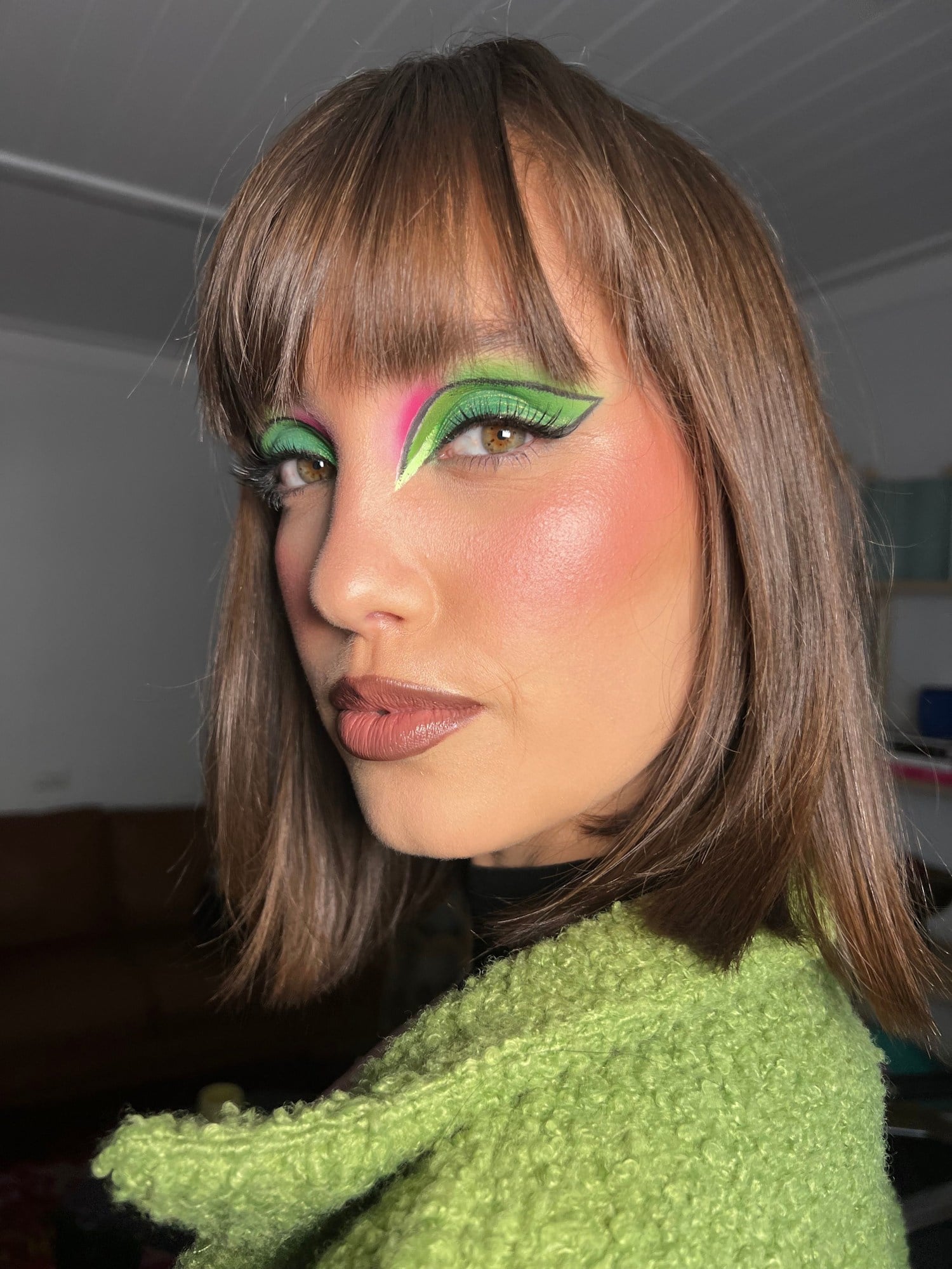 Green and pink graphic liner with a matching green knit
